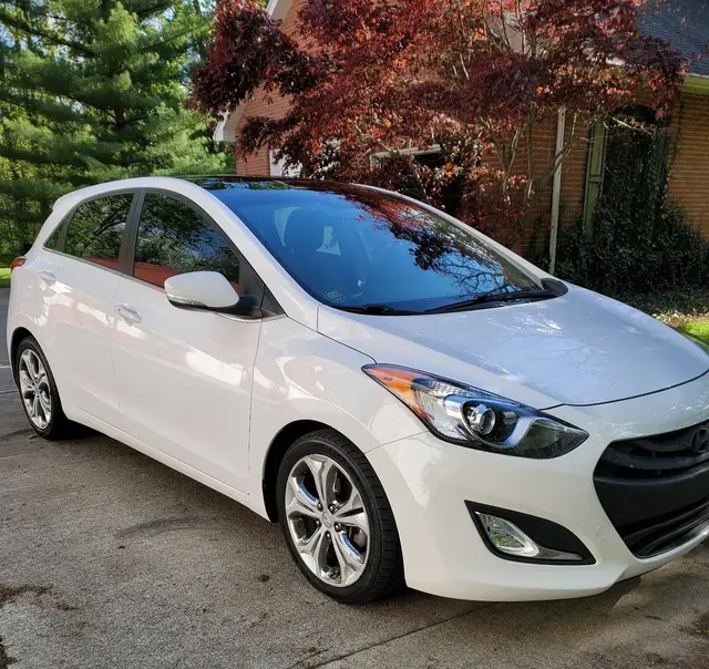 The white hatchback with its front bumper in one piece